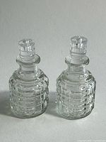 Front view of both cruet bottles with stoppers in place