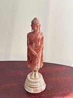 Front view of soapstone Buddha on pedestal