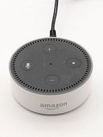 Top and side view of Amazon Echo Dot showing buttons and Amazon logo