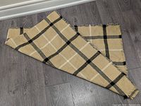 Full view of folded plaid blanket scarf