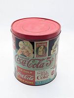 Front view of Coca-Cola tin showing main graphics and red lid