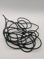 Coiled green extension cord showing plug and female connectors