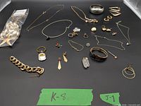 All jewelry pieces laid out on black background