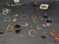 Full layout of assorted jewelry pieces on black background