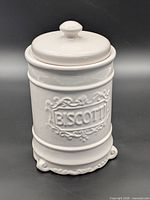 Front view of white ceramic biscotti jar with lid