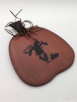 Front view showing pumpkin shape, silhouette design and raffia bow