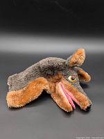 Left side view of plush wolf hand puppet