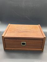 Front view of wooden floating nightstand closed