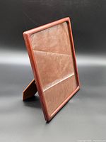 Front three-quarter view of wooden frame showing glazing and rounded edge