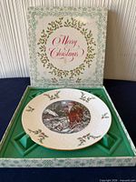 Plate in open presentation box showing Santa Claus scene, gold rim and box lid graphics