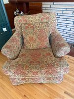 Front view of upholstered accent chair and pillow