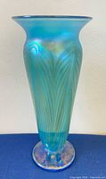 Full view of vase showing shape, color, pulled feather design and iridescent foot