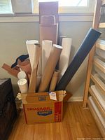 Box of assorted rolled papers and tubes