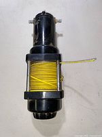Overall view of black Superwinch electric winch with yellow rope