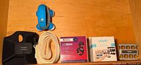 All five items laid out: wrist brace, stretching strap, MGMove box, finger exerciser box with device, blue massager