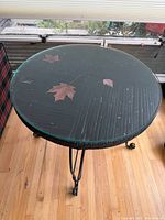 Top view showing rattan surface under round glass and overall tabletop condition