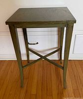 Front view of small green wooden side table