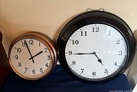 Both clocks side by side showing size difference and overall condition