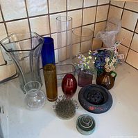 Group shot of all vases, flower frogs and glass stones