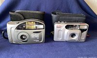 Front view of both cameras showing brands, models, lens and flash areas