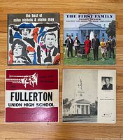 Front jackets of all four records displayed on floor