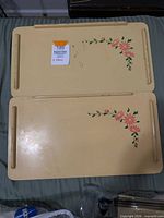 Top view of both trays folded flat showing floral motif and wear