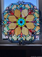Full view of round stained glass panel on window