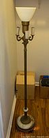 Full view of marble and brass torchiere floor lamp