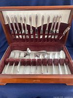 Open chest showing full place settings and serving pieces