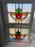 Both stained glass panels framed together showing overall design and size