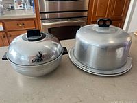 Royal aluminum cake carrier and West Bend bun warmer side by side