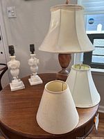 Overview of three alabaster lamps and three shades on table