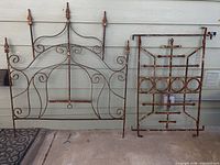 Full view of wrought iron headboard and gate panel side by side
