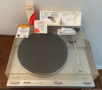 Overall view of Yamaha P-350 turntable with dust cover and Ortofon parts on top