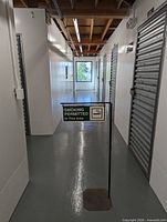 Front view showing printed sign face, post, and base