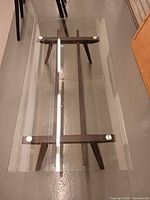 Full view of coffee table showing glass top and cast iron base