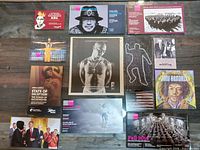 All thirteen prints laid out on wood surface