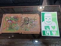 Overall view showing both artworks on table