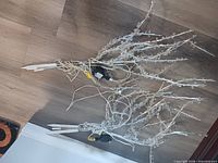 Both decorative LED branches unplugged, cords and stakes visible