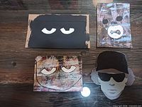 Front view of four painted cardboard pieces on table