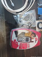 Overview of sealed Virgin Mobile phone, white Ethernet cable, bagged USB cable