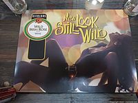 Full view of Richard's Wild Irish Rose advertising poster on table