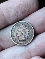 Obverse of 1906 Indian Head Cent held in hand