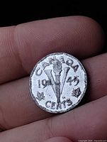 Reverse of 1945 Canada Victory nickel showing torch, V, maple leaves, denomination