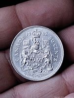 Reverse side of 1982 Canadian 50 cent coin showing Coat of Arms