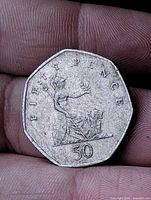 Reverse showing seated Britannia with lion and denomination 50