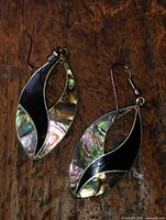 Front view highlighting abalone, black and coral inlay