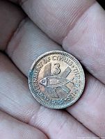 Reverse of 1955 Cyprus 3 mils coin showing fish design, denomination 3 and legend THREE MILS 1955