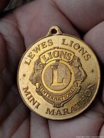 Obverse showing Lewes Lions Mini Marathon text and Lions International emblem