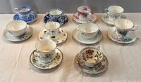 All ten tea cup and saucer sets displayed on table